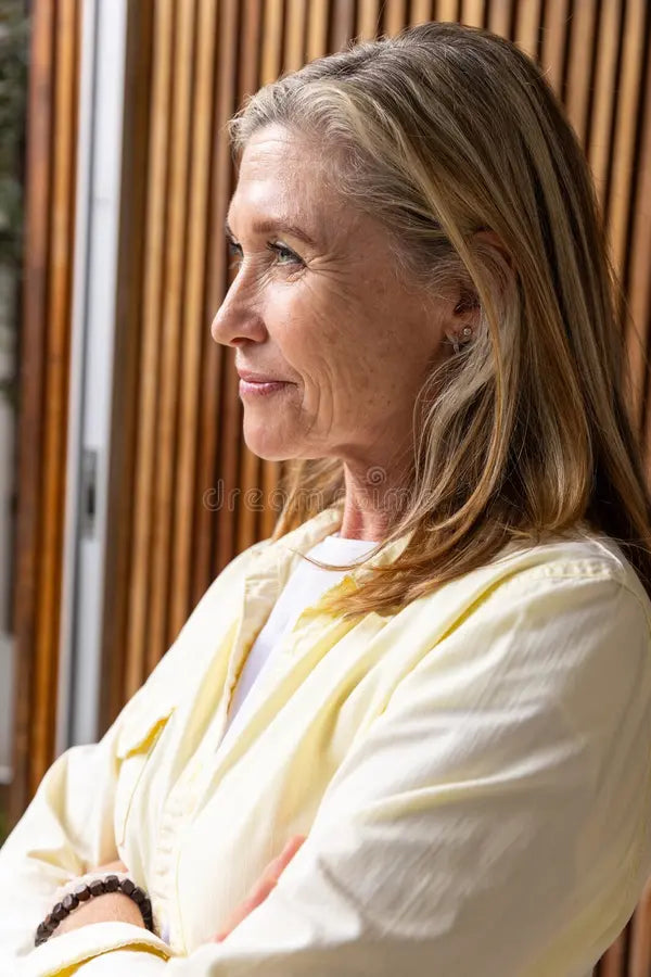 files/senior-woman-looking-out-window-living-room-slat-wall-wearing-shirt-beaded-bracelet-senior-woman-looking-out-window-433293840.webp